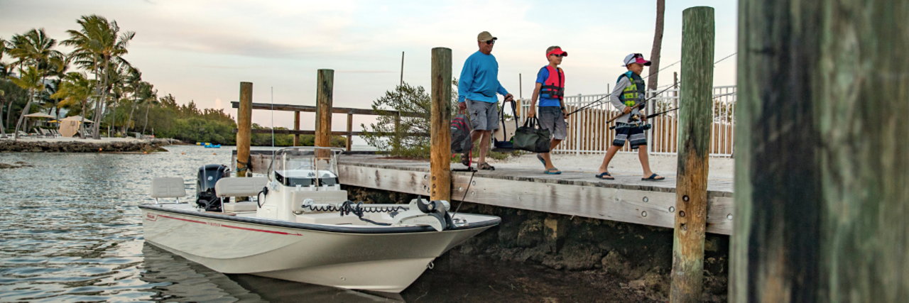 Father and sons walking on dock