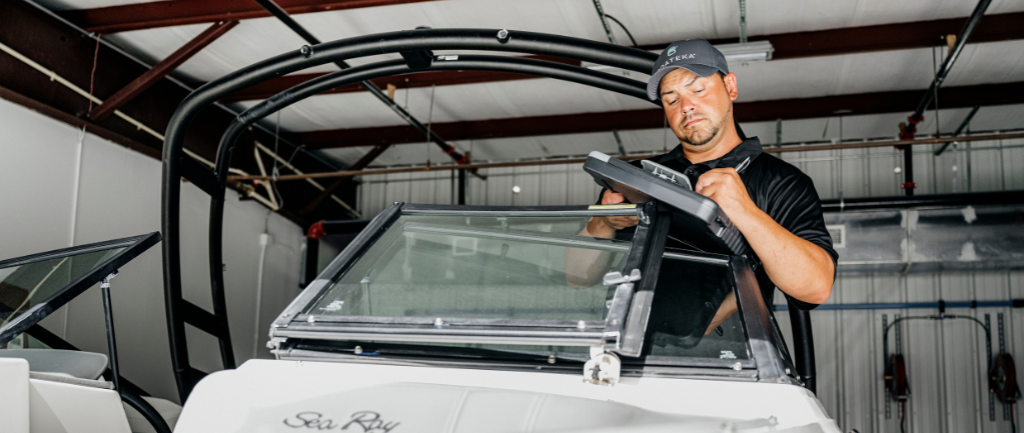 Boateka employee inspecting preowned boat