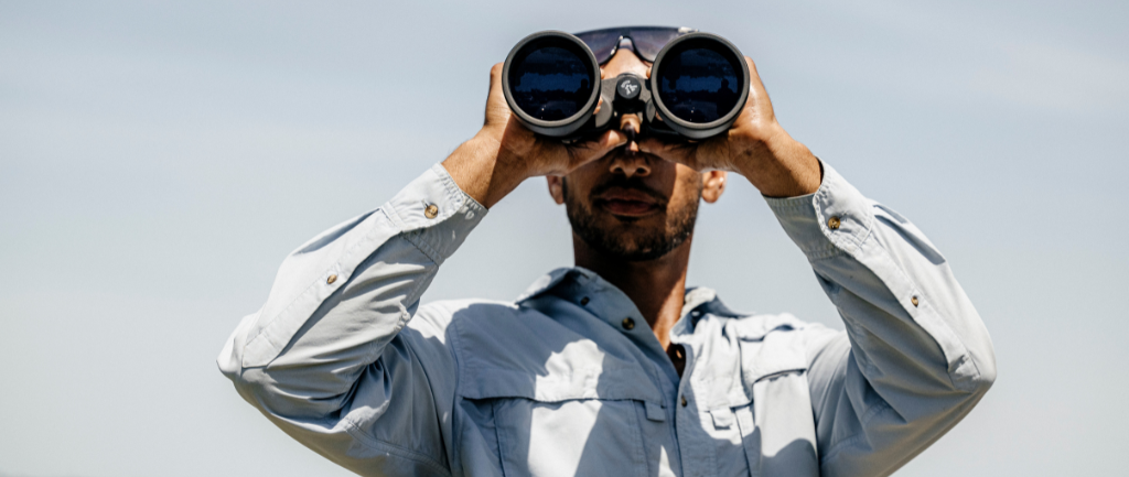 Man looking through binoculars